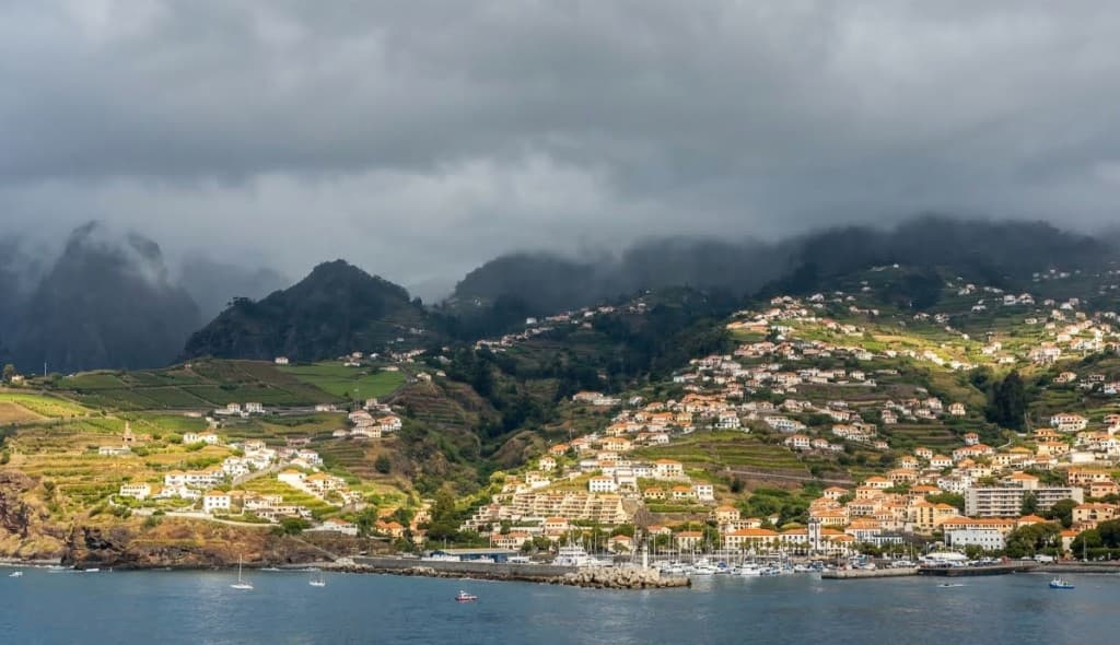 Madeira coastline with dramatic clouds and terraced hills